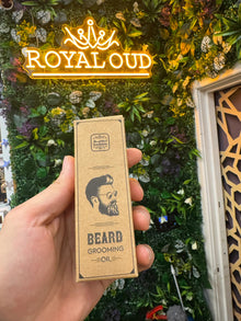 Hand holding Naseem beard grooming oil box in front of neon Royal Oud sign and green wall