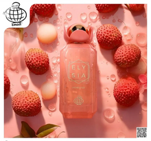 Elysia Lychee Fizz perfume bottle with fresh lychees and water droplets on a pink background
