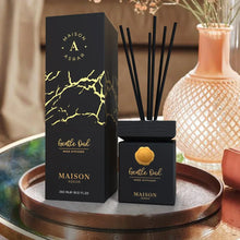 Gentle Oud reed diffuser by Maison Asrar with black sticks and gold accents on a tray.