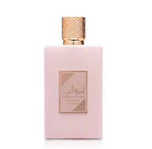 Pink Arabian oud perfume bottle with gold textured cap and rose label on white background