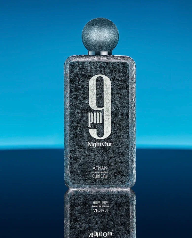 Afnan 9pm Night Out perfume bottle with textured black design on a blue reflective background.