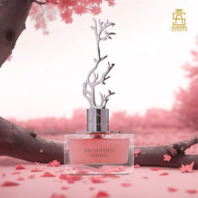 Close-up of Deciduous Spring perfume bottle with pink floral background