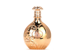 Gold Arabian oud perfume bottle with floral embossed design and NYLA label on white background