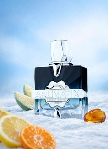 Luxury Aromatix French Avenue perfume bottle on snow with citrus slices and resin, sky background