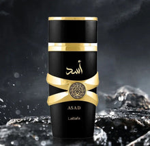 Black and gold Asad Lattafa Arabian oud perfume bottle with water splash background