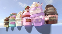 Colorful dessert-shaped perfume bottles resembling whipped cream and pastries, displayed outdoors.