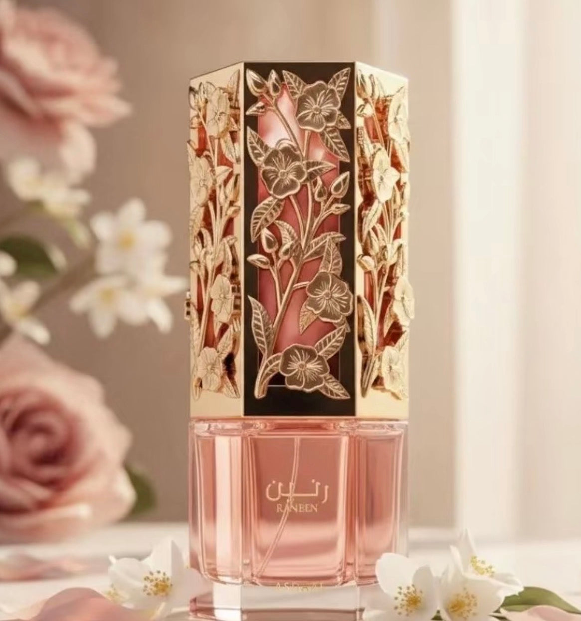 Decorative perfume bottle with floral designs on a light background