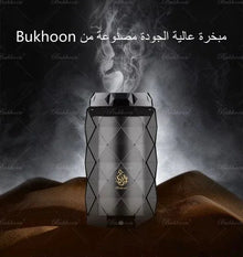 Luxury geometric bakhoor incense burner with smoke, set on desert sand, Arabian oud decor