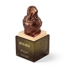Luxury Arabian oud perfume bottle with bronze sculpted bust cap, labeled MUHARIB Maison Asrar.