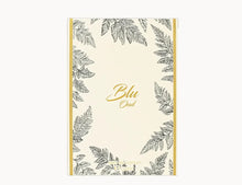 Blu Oud perfume box with gold text and black leaf illustrations on a cream background