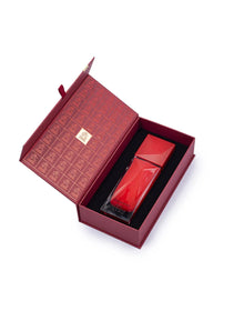 Elegant red Arabian oud perfume bottle in luxurious red gift box on white background