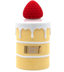 Coconut Chiffon perfume bottle shaped like a cake with white icing and a red strawberry cap.
