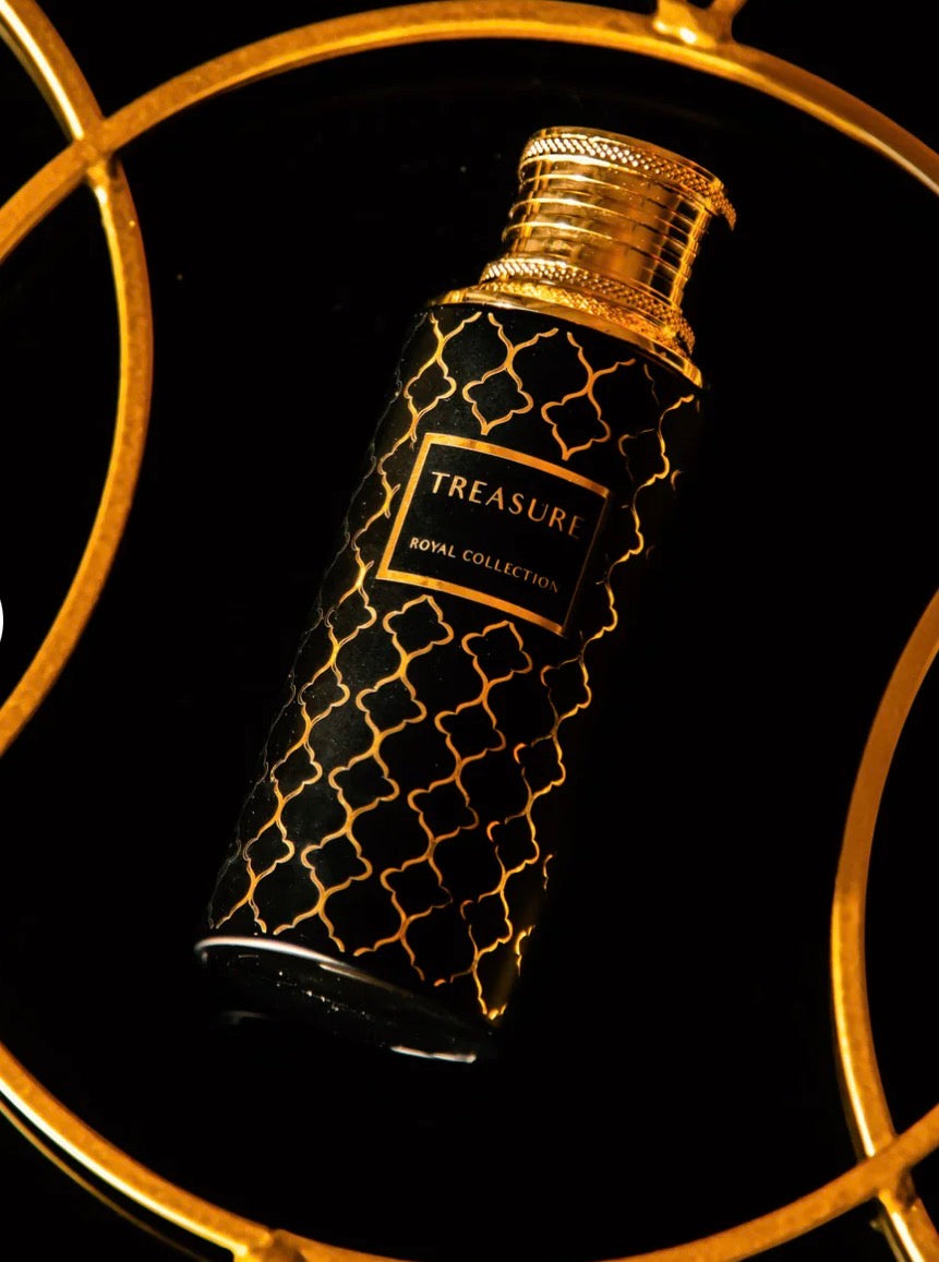 Decorative perfume bottle with gold accents on a black background