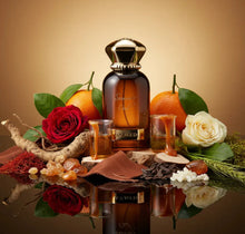 Arabian oud perfume bottle surrounded by oranges, red and white roses, resin, roots, and spices