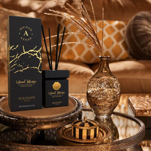Wood Intense reed diffuser in luxury packaging on a decorative table, with golden home decor.