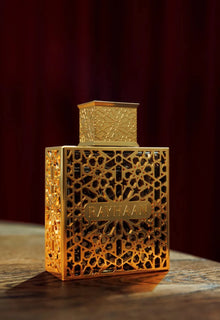 Luxurious gold Arabian oud perfume bottle with intricate geometric pattern, labeled Rayhaan