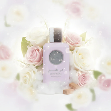 Dirham Wardi perfume bottle surrounded by white and pink roses, soft floral background, Arabian fragrance.