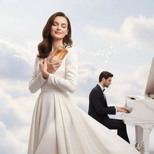 Elegant woman in white dress holding oud perfume bottle, man in tuxedo playing white piano, clouds background