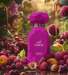Purple Arabiyat Prestige perfume bottle surrounded by raspberries, honey, and fruits in a natural setting