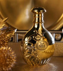 Luxurious gold Arabian oud perfume bottle with ornate detailing on a golden background
