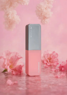 Pink and grey Arabian oud perfume bottle labeled FLORAISON, with pink flowers on a pink background.