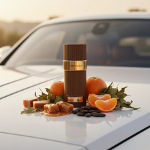 Brown perfume bottle labeled 'Tobacco' with tangerines, caramel, and tonka beans on a car hood