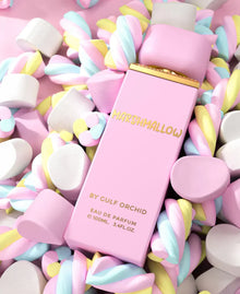 Pink Marshmallow Eau de Parfum bottle by Gulf Orchid surrounded by colorful marshmallows