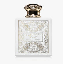 Essence de Blanc eau de parfum bottle with gold ornate cap and intricate white floral design.