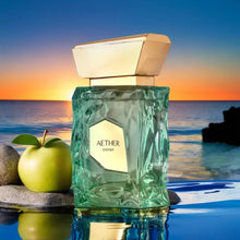Elegant Aether Extrait perfume bottle with green apple on rocks by ocean sunset
