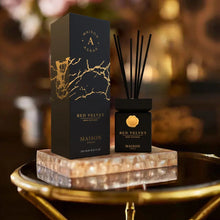 Luxury Maison Asrar Red Velvet reed diffuser set with black and gold packaging on marble tray