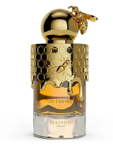 Luxury gold honeycomb perfume bottle with bee detail, labeled Oh Honey by Maison Asrar.