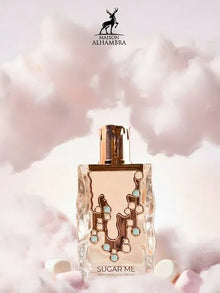 Maison Alhambra Sugar Me Marshmallow Dream perfume bottle with gold details amid pink clouds