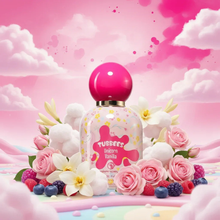 Unicorn Vanilla perfume bottle with pink cap, surrounded by roses, berries, white flowers, and pastel clouds on a dreamy pink background.