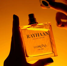 Hand holding RAYHAAN Floriana Eau de Parfum bottle for her on warm golden background