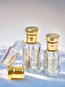 Elegant glass perfume bottles with gold caps for women's fragrance