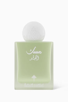 Elegant light green Arabian perfume bottle with white Arabic script and frosted round cap