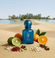 Blue Laverne Elixir perfume bottle with citrus fruits, spices, and oud on desert sand background