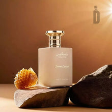 Caramel Cascade perfume bottle with gold cap, honeycomb and rocks on a warm brown background