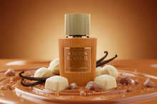 Molten Caramel perfume bottle with gold cap, surrounded by caramel, pralines, and vanilla pods.