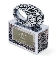 Luxury Arabian oud perfume bottle with intricate Arabic calligraphy and geometric patterns