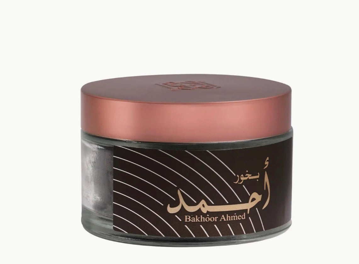 Close-up of Bakhoor Ahmad woody incense jar with pink lid