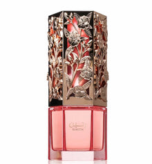 Decorative perfume bottle with intricate designs on a white background