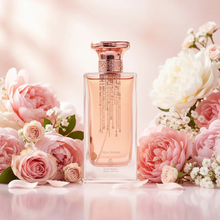 Elegant Mon Amour perfume bottle with rose gold accents, surrounded by pink and white flowers