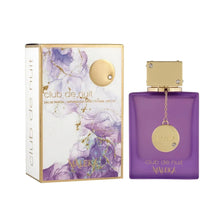 Club de Nuit Maleka perfume with gold cap and purple bottle beside floral packaging.
