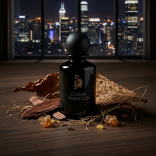 Luxury Cuban Tobacco perfume bottle with oud, amber, and tobacco leaf on a wooden table, city skyline in background.