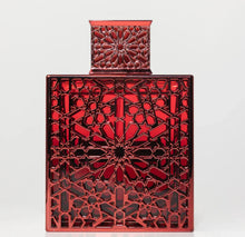 Red Arabian oud perfume bottle with intricate geometric arabesque pattern on white background