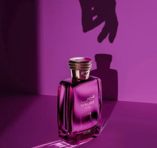 Purple Nawaas Diva for Her Arabian perfume bottle with gold cap on pink background