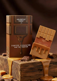 Toffee Ganache eau de parfum bottle and box designed like chocolate, surrounded by melted toffee and chocolate pieces.