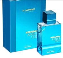 Al Haramain Amber Oud Aqua Dubai perfume bottle and box in metallic blue packaging