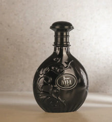 Black Arabian oud perfume bottle labeled NYLA Suede with embossed floral design